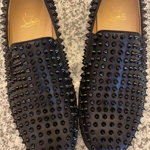 Christian Louboutin designer Roller Boat shoes with spikes. Black in color.